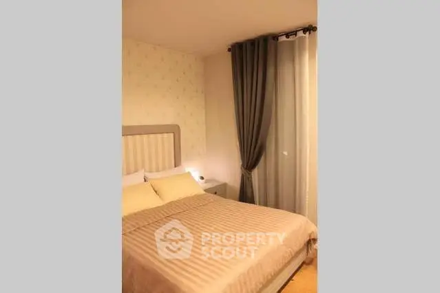 Cozy bedroom with elegant curtains and soft lighting, perfect for relaxation.