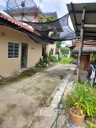 Charming rural property with spacious outdoor area and lush greenery, perfect for tranquil living.