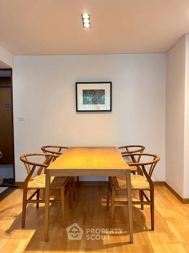 Elegant dining area with wooden table and chairs, perfect for modern living spaces.