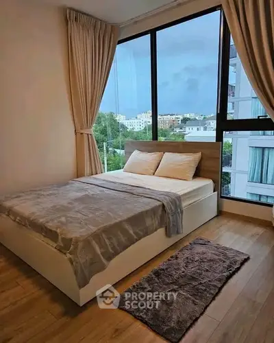 Modern bedroom with large windows and scenic view in a stylish apartment