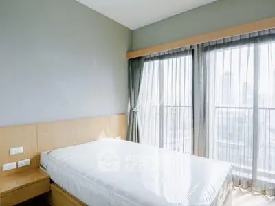 Bright and airy bedroom with large windows and city view