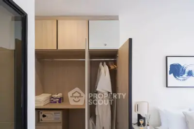 Modern bedroom with open wardrobe showcasing organized storage and stylish decor.