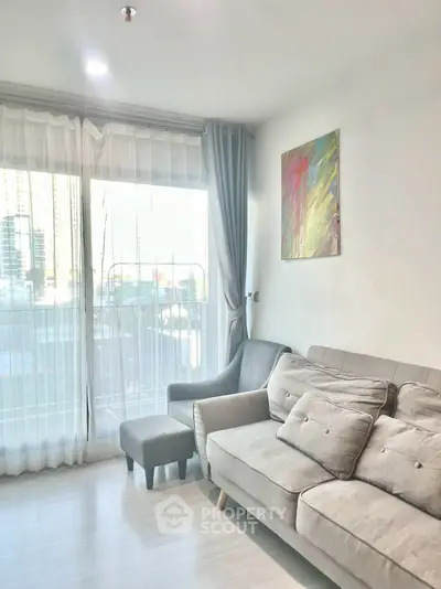 Bright living room with modern sofa and city view through large windows.