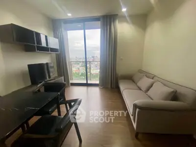 Modern living room with city view, featuring sleek furniture and large windows for natural light.