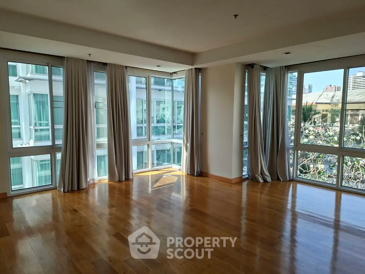 Spacious corner unit with floor-to-ceiling windows and hardwood floors