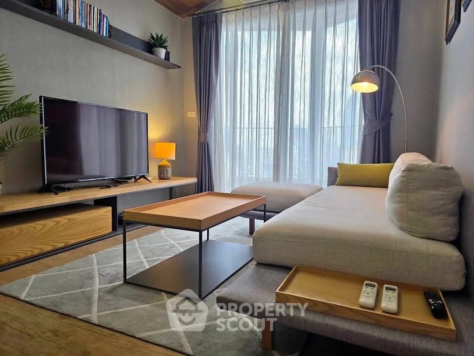 Modern living room with stylish furniture and large TV, perfect for relaxation and entertainment.