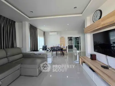 Spacious modern living room with sleek furniture and open dining area