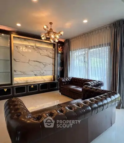 Luxurious living room with elegant leather sofas and marble accent wall
