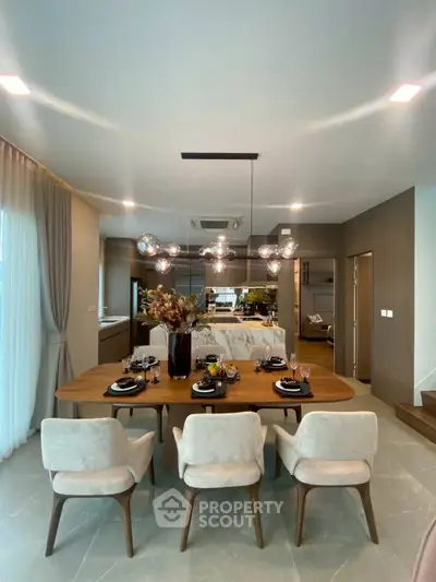Elegant dining area with modern chandelier and stylish decor in a contemporary home setting.
