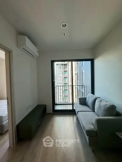 Modern living room with balcony view and sleek furniture in urban apartment