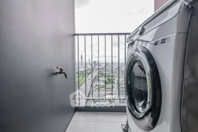 Modern balcony with washing machine and stunning city view, perfect for urban living.