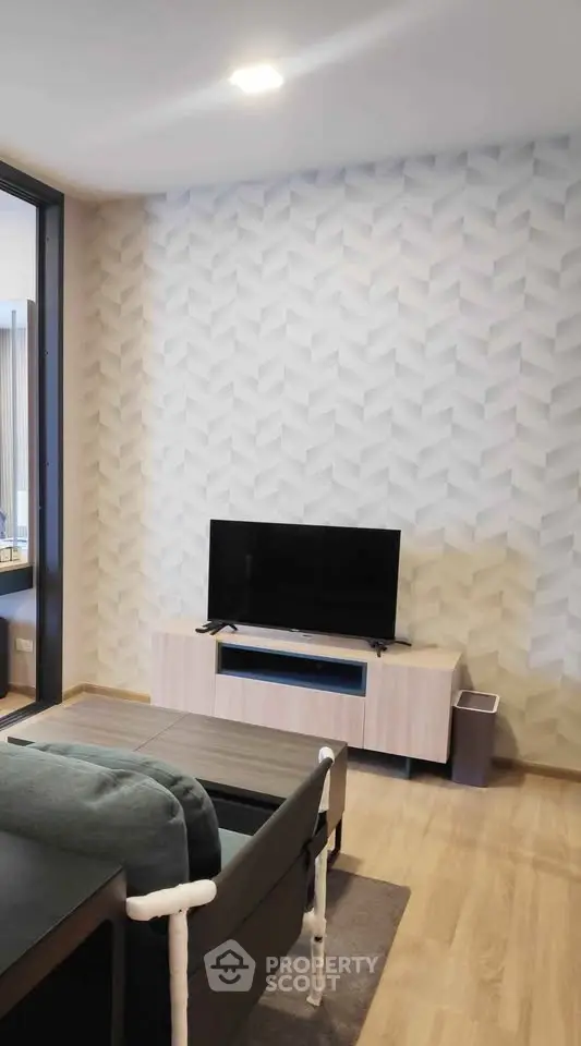 Modern living room with stylish wallpaper and sleek TV stand, perfect for contemporary living.