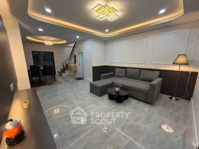 Spacious modern living room with elegant lighting and stylish decor, perfect for comfortable living.