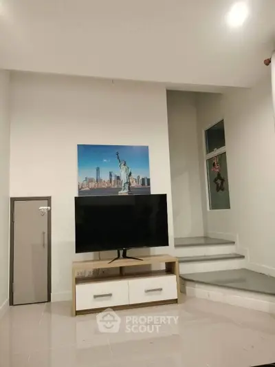 Modern living room with stylish TV stand and wall art