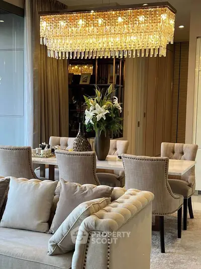 Luxurious living room with elegant chandelier and plush seating, perfect for sophisticated gatherings.