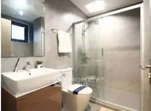 Modern bathroom with sleek fixtures and glass shower enclosure
