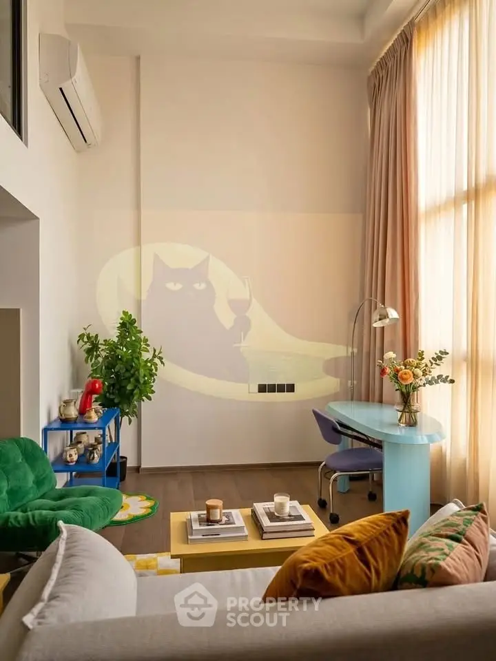 Stylish living room with high ceilings, modern furniture, and large windows for natural light.