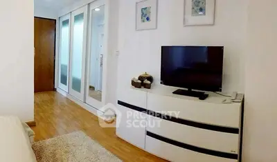 Modern bedroom with sleek TV setup and stylish storage solutions.