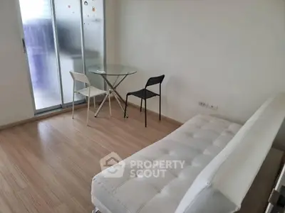 Modern minimalist living room with glass table and white sofa