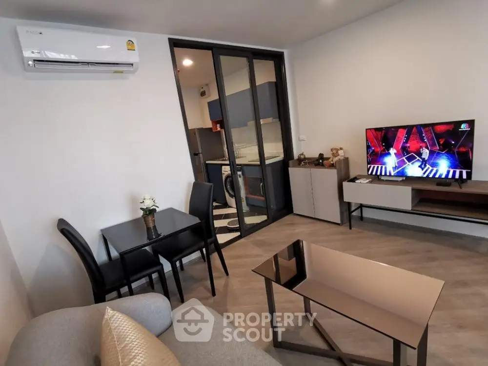 Modern living room with sleek furniture and open kitchen layout