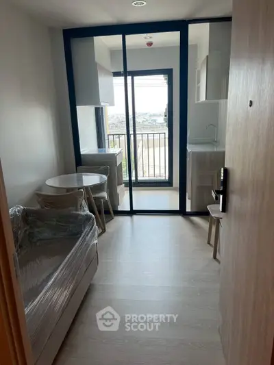 Modern compact apartment with open kitchen and balcony view