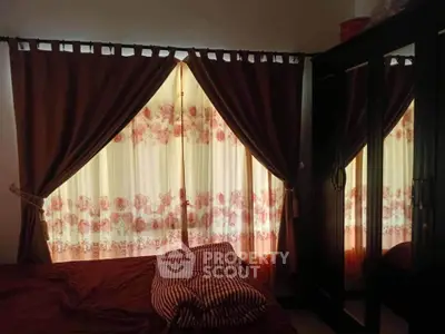 Cozy bedroom with elegant curtains and mirrored wardrobe