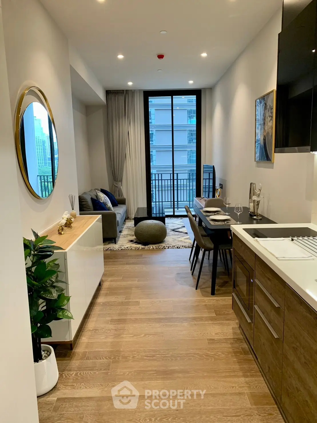 Modern open-layout living room with stylish decor and balcony view