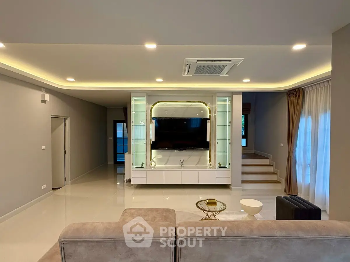 Spacious modern living room with elegant lighting and stylish decor