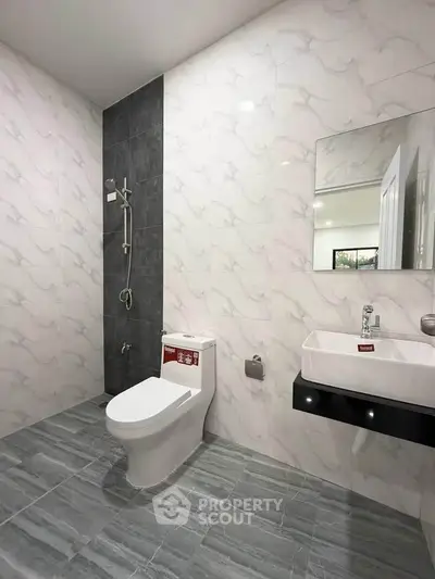 Modern bathroom with sleek fixtures and elegant tile design.