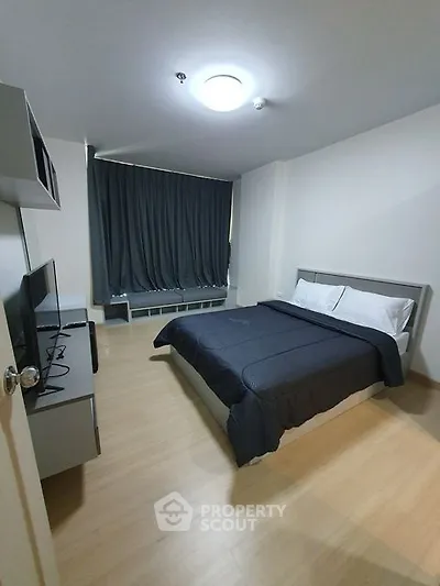 Modern bedroom with sleek design and cozy ambiance, featuring a comfortable bed and stylish decor.
