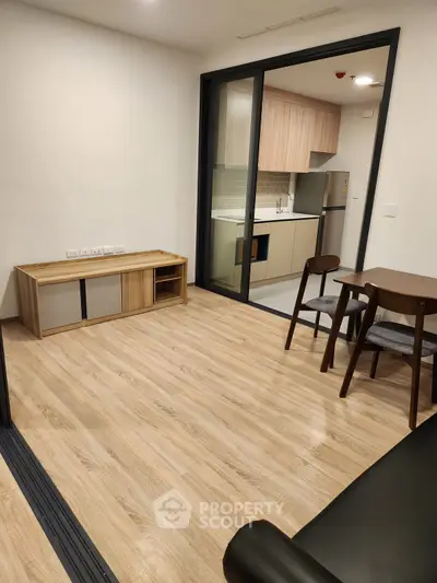 Modern open-plan living room with sleek kitchen and dining area