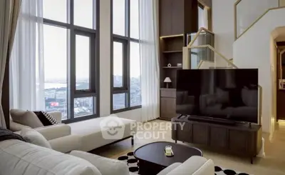 Luxurious modern living room with high ceilings and stunning city view