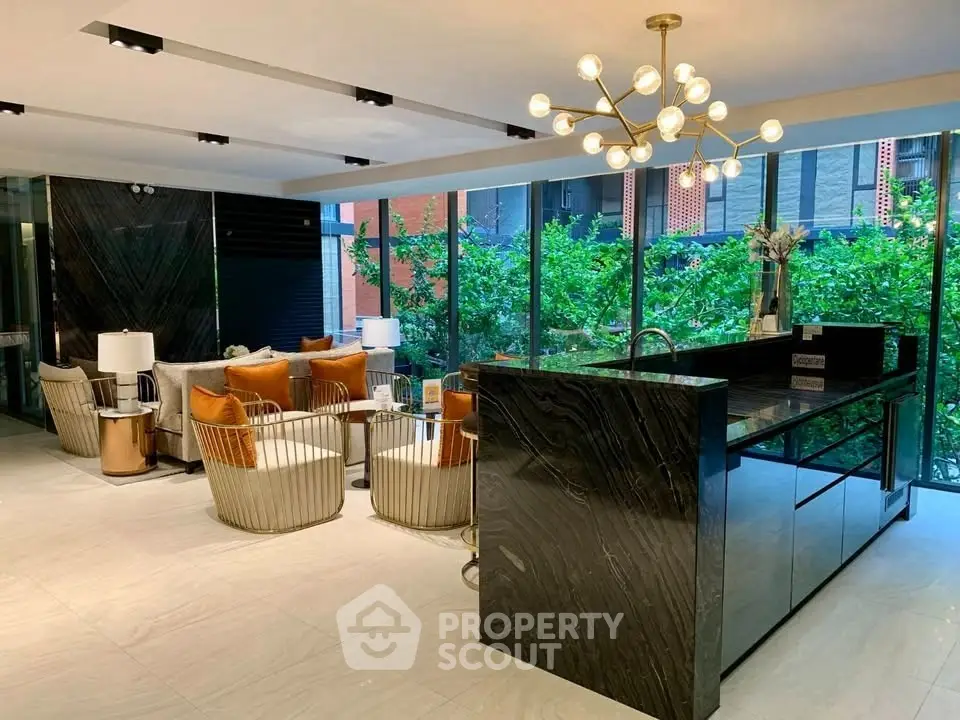 Luxurious modern living room with elegant decor and large windows overlooking greenery.