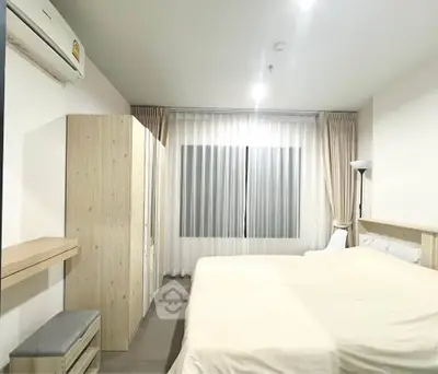 Spacious bedroom with modern furnishings and ample natural light