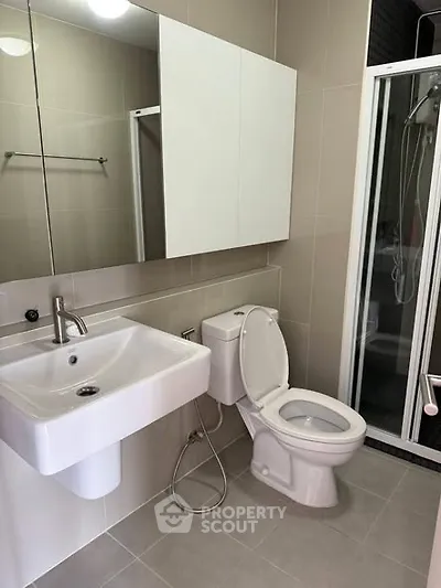 Modern bathroom with sleek fixtures and glass shower enclosure