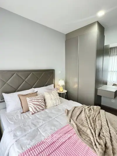 Cozy bedroom with modern decor and plush bedding in a stylish apartment.