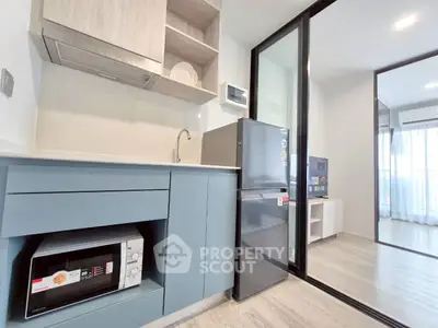 Modern kitchen with sleek appliances and open layout in a bright apartment