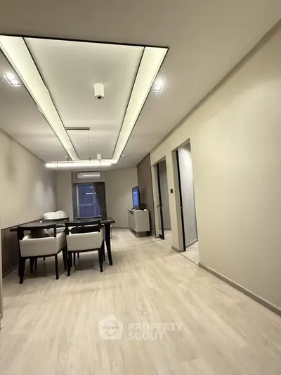 Modern dining area with sleek lighting and minimalist decor in a contemporary apartment.