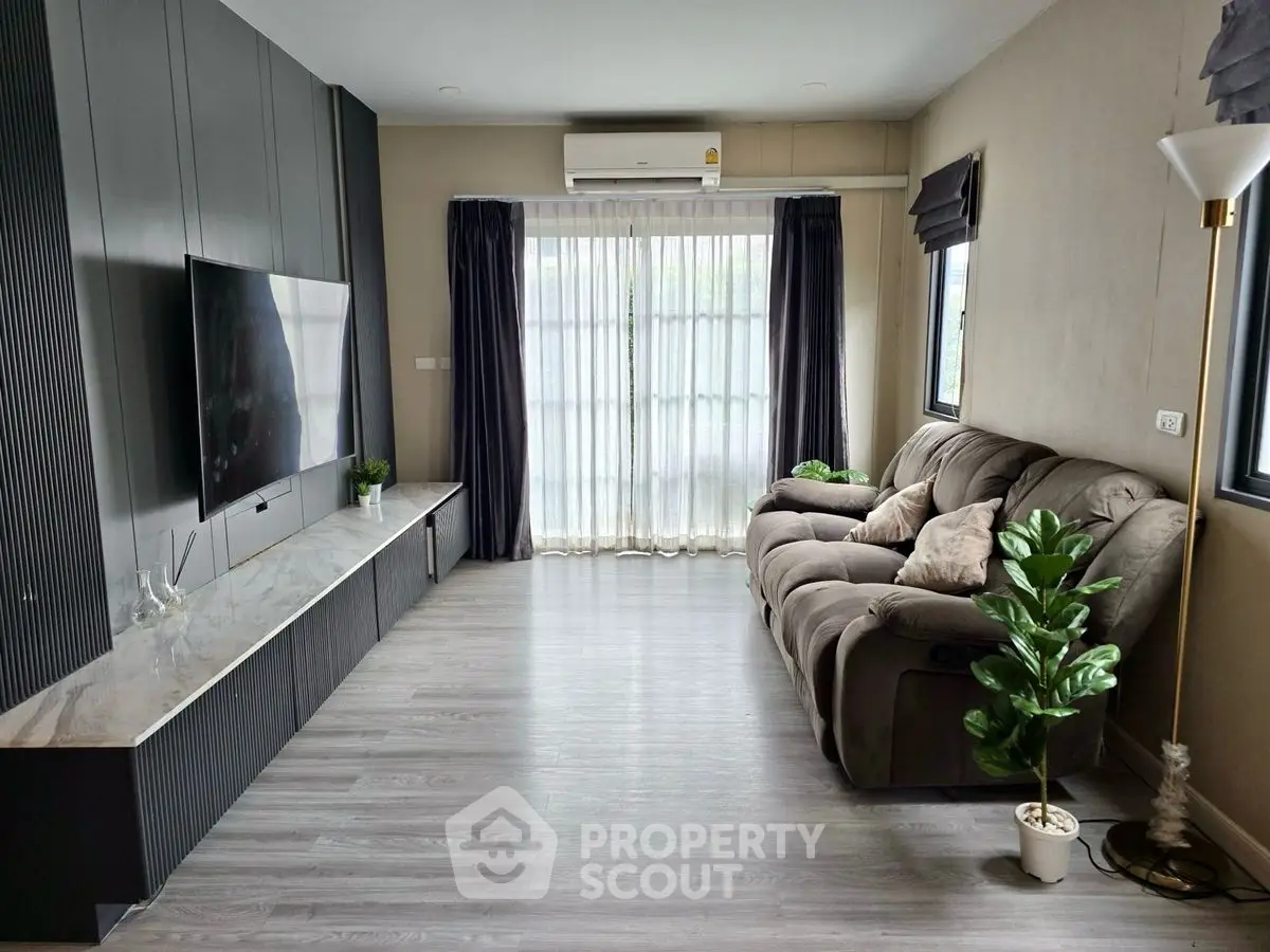 Modern living room with sleek TV setup and cozy seating area