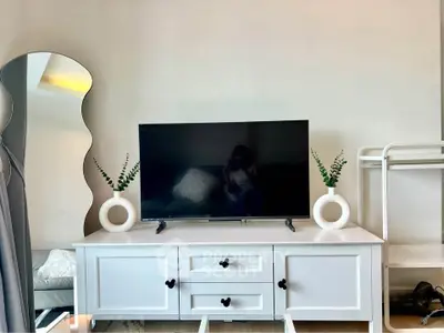 Modern living room with stylish TV stand and unique mirror design