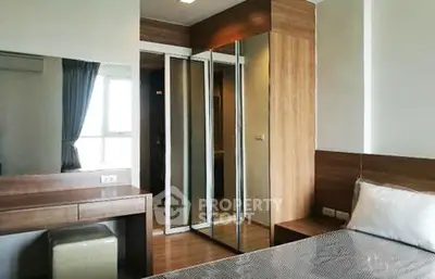 Modern bedroom with mirrored wardrobe and stylish wooden furniture