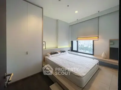 Modern bedroom with large window and minimalist design in urban apartment