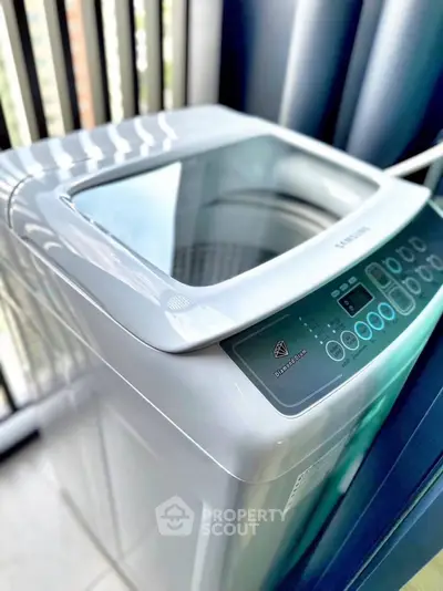 Modern washing machine in a bright laundry area with natural light