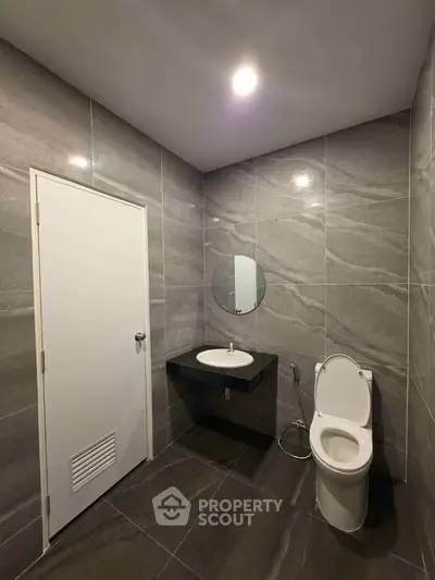 Modern bathroom with sleek gray tiles and minimalist fixtures