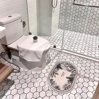 Modern bathroom with geometric tiles and glass shower enclosure