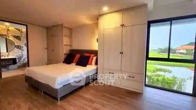 Spacious bedroom with scenic view and modern furnishings