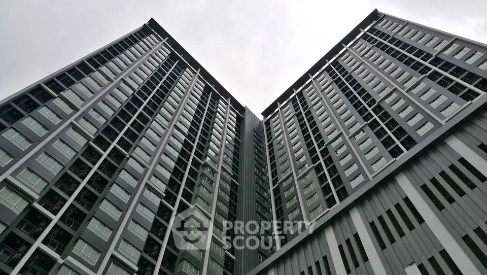 Modern high-rise building with sleek architectural design and expansive glass windows.