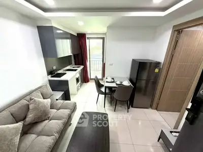 Modern compact living room with open kitchen and dining area, featuring sleek furniture and appliances.