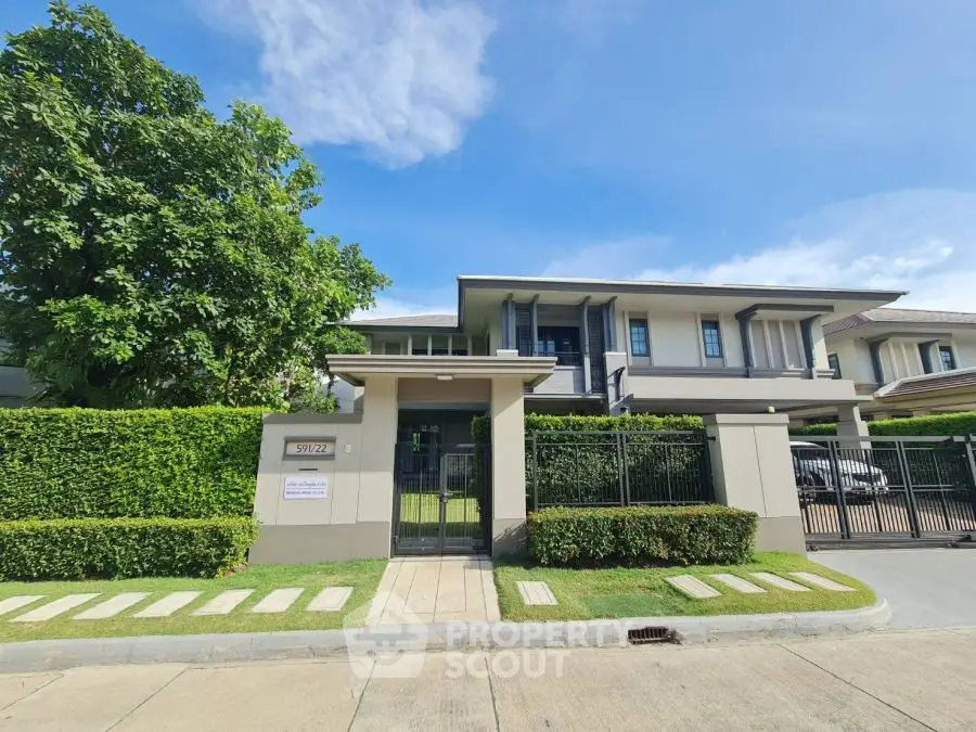 Modern two-story house with lush greenery and spacious driveway in a serene neighborhood.