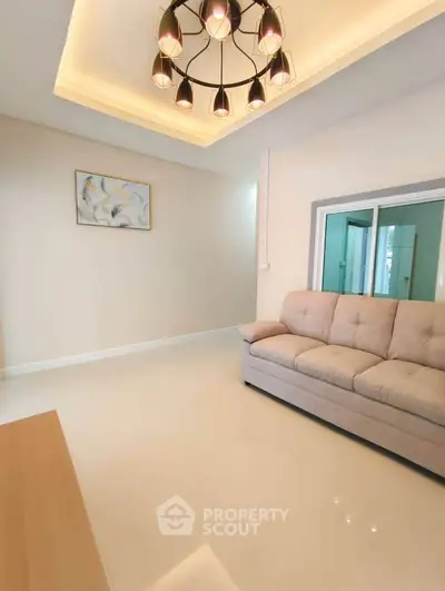 Modern living room with elegant lighting and cozy sofa in a stylish apartment.